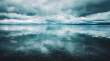 Calm lake reflecting cloudy skies in a tranquil natural setting photo