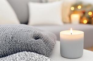 Cozy living room setting with lit candles and soft blankets during festive season photo