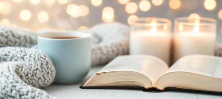 Cozy evening reading with candles and soft blanket by glowing lights photo