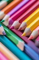 Colorful arranged colored pencils on a white surface in a creative workspace photo
