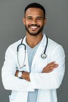 Smiling doctor in a white lab coat with a stethoscope posing confidently indoors photo