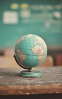 Vintage globe resting on a wooden table in a classroom setting photo