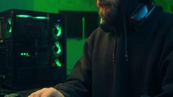 Hands typing keyboard computer Caucasian man programmer hacker looking at camera wink guy ai server system virus dangerous hooded male security hacking pc attacking code scam cyber password connection video