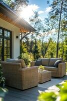 Cozy outdoor seating area with rattan furniture surrounded by trees on a sunny day photo