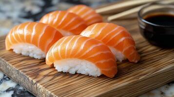 Fresh salmon sushi served on a wooden board with soy sauce and chopsticks photo