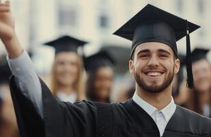 Graduate celebrating with a fist pump during the ceremony at a university campus in spring photo