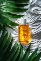 Botanical drops on textured surface with green leaves and liquid container photo