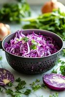 Chopped purple cabbage salad with fresh greens on a wooden cutting board photo