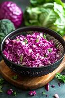 Chopped purple cabbage salad with fresh greens on a wooden cutting board photo