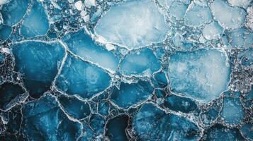 Cracked blue ice with clear water beneath at a frozen lake during winter photo
