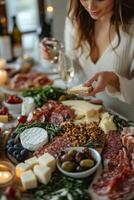 Elegant charcuterie board with cheeses and meats at a candlelit gathering photo