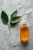 Botanical drops on textured surface with green leaves and liquid container photo