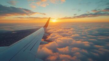 Sunrise view from an airplane window above the clouds during early morning flight photo