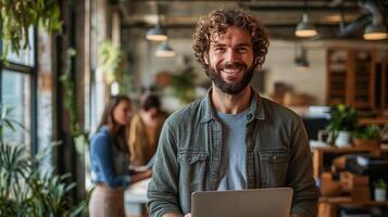 Professional man standing confidently with laptop in a modern office space photo