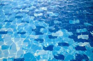 Swimming pool water sun reflection background. Ripple Water. photo