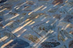 top view of the floor composed of travertine tiles in warm beige hues photo