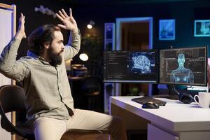 Self aware AI gaining anthropomorphic form inside cyberspace, scaring software technician jumping from chair. Artificial intelligence becoming sentient, startling IT admin raising hands in fear photo