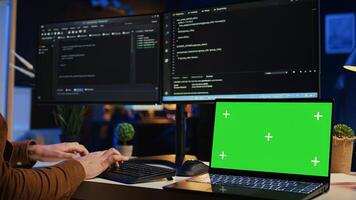 Green screen laptop in home office used by programmer for developing software applications. Mockup notebook used by teleworking IT specialist for programming, camera B close up photo