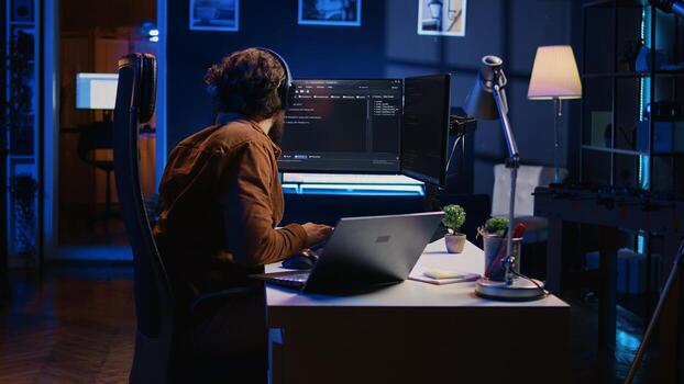 Hyperactive software developer suffering from adhd affliction, writing code, drinking coffee, listening music, arranging desk objects. Distracted IT admin doing multitasking in home office, camera B photo