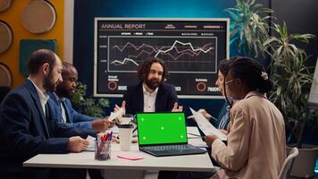 Product management team developing strategies with mockup display on laptop, sharing insight on projects and expressing concerns. Employees collaborating on enterprise growth. Camera B. photo