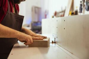 Woodworking professional operating wood shaper in assembly shop, creating intricate designs with precision. Cabinetmaker uses spindle moulder to shape and mold wooden pieces, close up shot photo