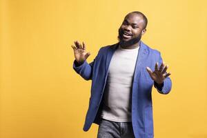 Portrait of fresh sharp african american man exuding self assurance, isolated over studio background. Expressive carefree BIPOC person looking dapper, posing nonchalantly and smiling photo