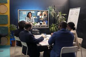 Project team attending a videocall meeting with associates, creating a presentation to give insight on project plans. Employees and stakeholders discuss on remote videoconference. photo