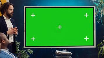 Startup team using greenscreen interactive board in a strategy workshop meeting, working together to improve their skills and performance. Corporation employees prepare for collaboration. Camera A. photo