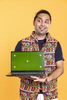 Portrait of happy worker holding isolated screen laptop, doing important work for company, studio background. Jolly employee with chroma key device at work solving job tasks photo