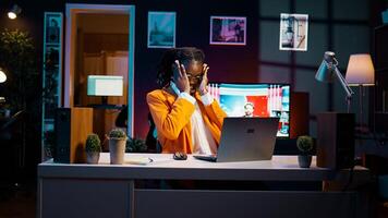African american student communicating with professors and classmates on online class videocall, using academic web connection platforms. Girl participating in webinar college lesson. Camera B. photo