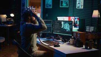 Man puts EEG headset on to transfer mind into computer virtual world, becoming one with AI superintelligence. Engineer using futuristic neuroscientific technology to transfer consciousness, camera B photo