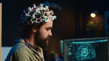 Engineer puts EEG headset on, links brain to cyberspace, conducts experiments. Man merging mind with artificial intelligence, uploading consciousness, achieving superintelligence, camera A close up photo