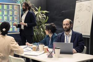 Management assistant working on annual report plan during a meeting, solving conflicts or concerns among team members before starting important project. Organizational development. photo