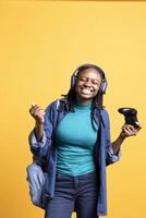 Delighted person playing intense gaming console game, celebrating win, studio background. Ecstatic woman excited after being victorious in videogame, defeating all enemies using controller photo
