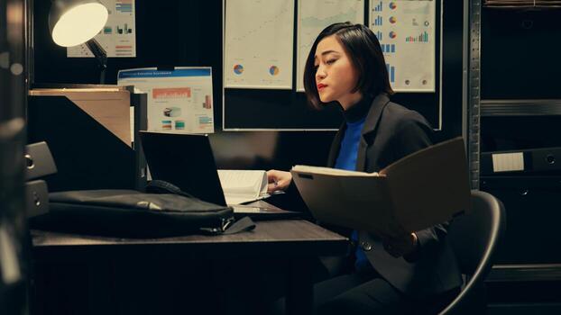 Law agent compares witness statements and interviews across investigations, trying to find similarities with archived files. Detective searches for connections between unrelated cases. Camera B. photo