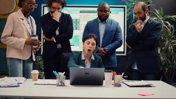 Frustrated angry project manager acting crazy and judging her staff members, reviewing their work and accomplishments. Mad irritated supervisor being displeased with the firm workflow. Camera B. photo