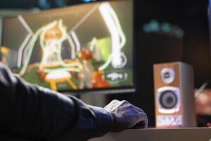 Player using keyboard and mouse to play first person shooter videogame on PC, enjoying leisure time. Man in living room using high tech computer peripherals to destroy enemies, close up photo