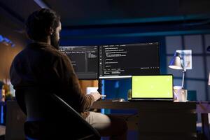 Developer working from home in apartment on green screen laptop, futureproofing company network from downtimes . Admin using chroma key notebook, increasing data security, close up photo