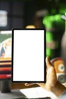 Close up shot of mockup tablet held by man in neon lit apartment while playing videogame on gaming PC. Isolated screen portable device used by person in RGB illuminated home photo