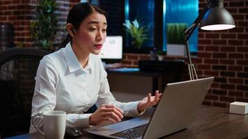 Worker greeting colleagues during business meeting on videocall in office, using online teleconference to discuss company strategy. Employee participating in remote videoconference telework call photo