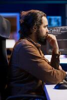 Software technician filtering malicious traffic from cybercriminals attempting to corrupt company data. IT admin working on computer, preventing malware and phishing attacks photo