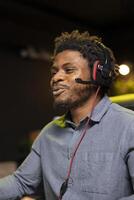 African american man feeling happy while playing videogames on computer desktop, celebrating victory. Cheerful gamer smiling after winning game on gaming PC, close up shot photo