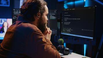 Cheerful software technician feeling satisfied after removing all bugs while coding on computer, close up. Smiling IT expert looking at screen, happy after solving script errors, camera B photo