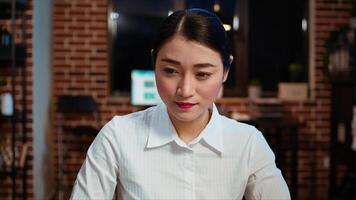 Zoom in on smiling businesswoman inputting financial data on laptop and analyzing sales report to plan business development. Close up of worker in office using device to do project research, camera A photo