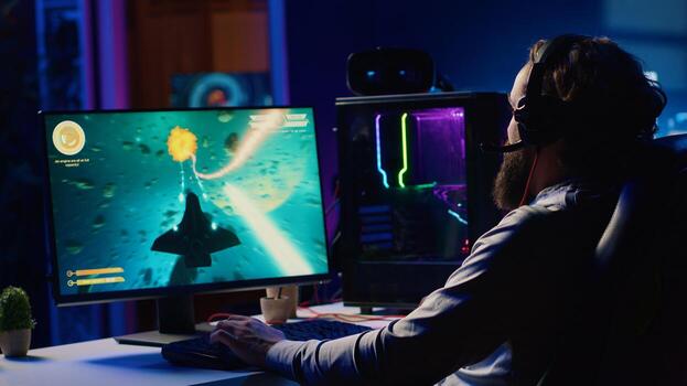 Man at home shooting asteroids in spaceship flying singleplayer game with overlay HUD showing health, fuel, ammo bars and minimap. Gamer navigating universe in simulation game, chatting with friends photo