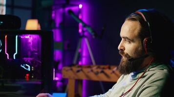 Zoom in on man discussing with friends online while playing singleplayer videogame with spaceship shooting at asteroids. Close up of gamer chatting with teammates while hitting targets in SF game photo