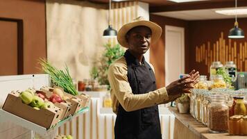 POV of storekeeper presenting his organic products on , working on new ad commercial to promote local farming nonpolluting business. Merchant talking about ethically sourced items. Camera 1. photo
