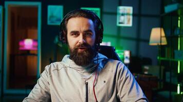 Esports player playing videogames in front of internet subscribers during livestream, providing engaging commentary while fighting foes. Zoom in shot of professional gamer streaming game photo