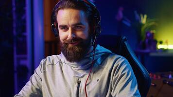Content creator chatting with audience while playing online multiplayer videogame on PC, contending against other live esports pro players. Close up shot of pro gamer broadcasting game on internet photo