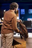 Programmer packing backpack, leaving office after implementing security measures, protecting company systems and data. IT worker ending work shift after finishing tasks and debugging code photo